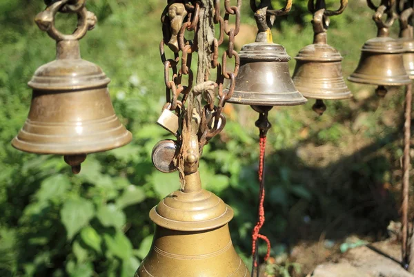 Little bronze bells in a row.