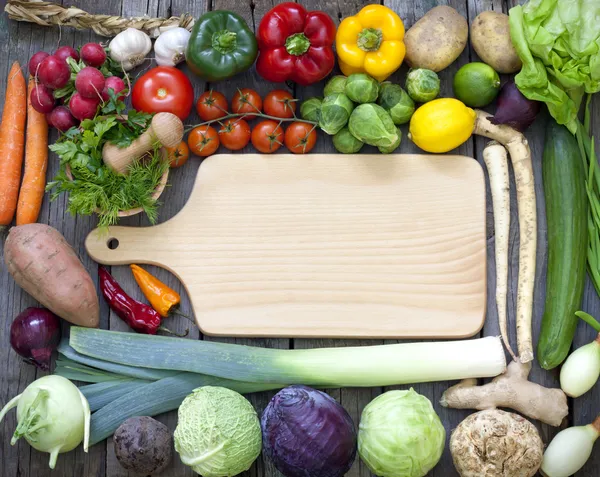 Vegetables and spices vintage border and empty cutting board