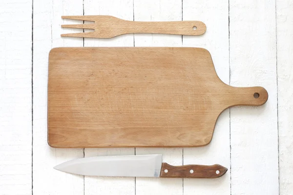 Empty cutting board on white planks food background concept