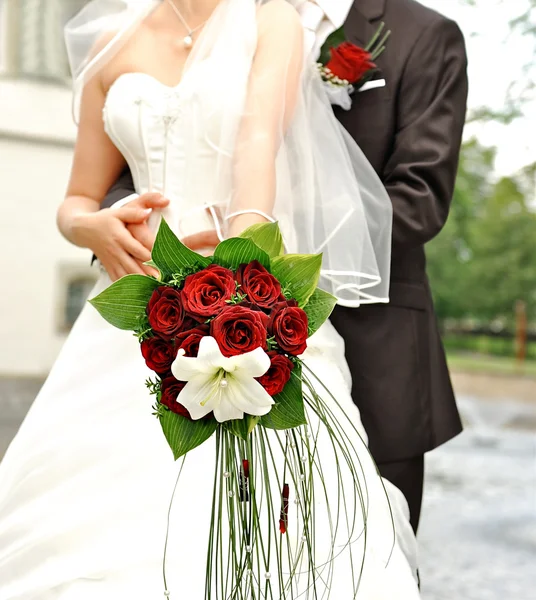 Bride holding beautiful red roses. wedding flowers bouquet