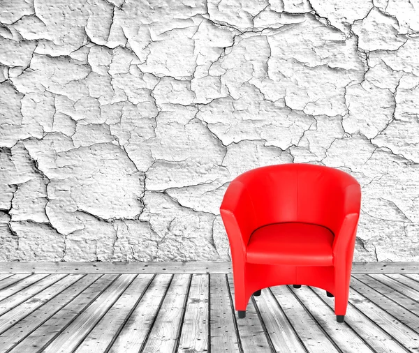 Red chair, white cracked wall and wooden floor