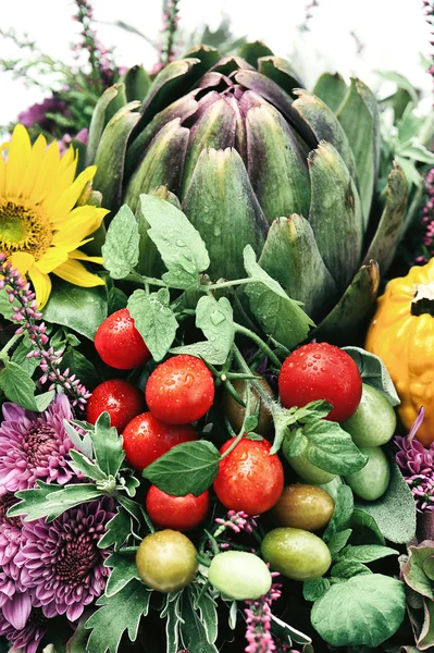 Artichoke, tomatoes and flowers arrangement