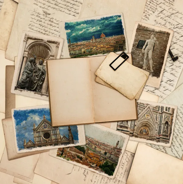 Open old book and postcards with pictures of florence