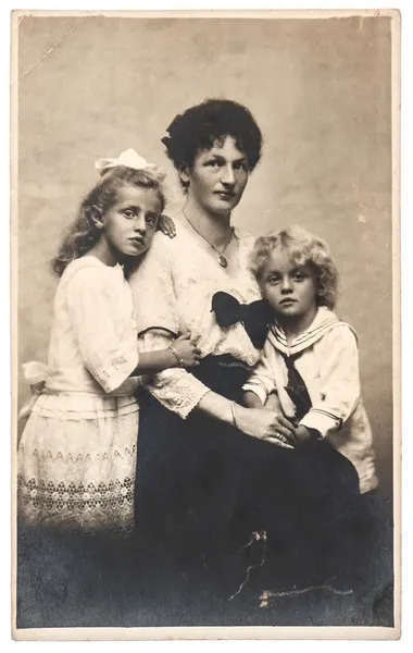 Antique family portrait of mother with children wearing vintage