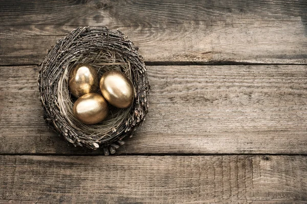 Golden easter eggs on wooden background
