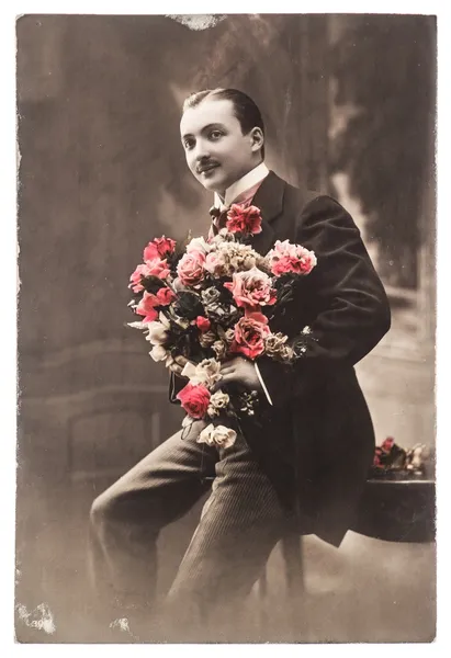 Young man with rose flowers. vintage photo