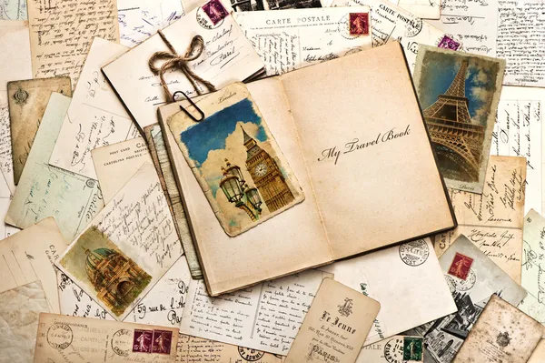 Old postcards, letters, mails and open travel book
