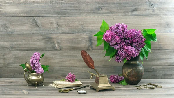 Vintage still life with lilac flowers in vase