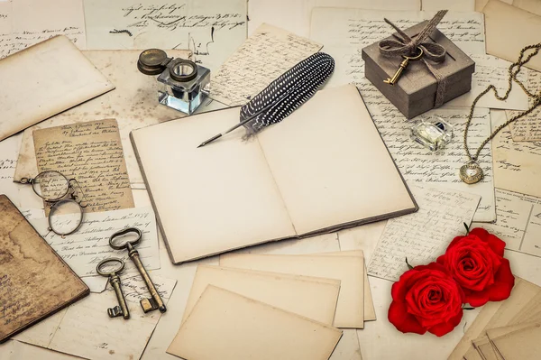 Diary book, old love letters and red rose flowers