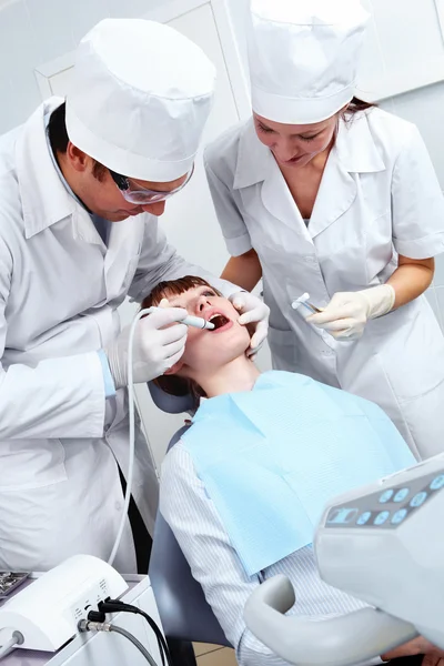 Image of doctor healing patient's teeth