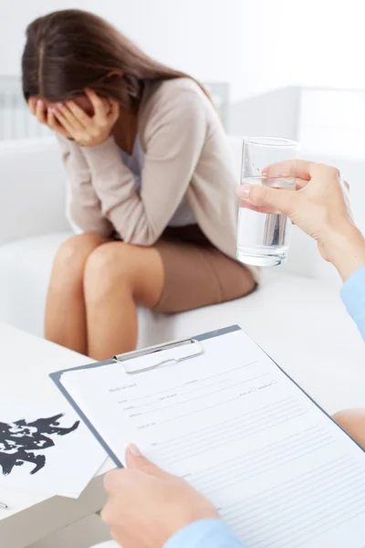 Upset patient sitting on psychiatrist couch