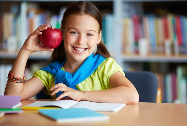 Schoolgirl with big red apple
