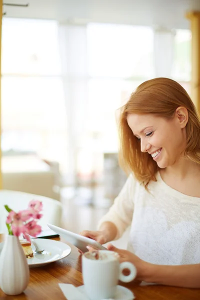 Woman using touchpad in cafe