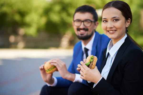 Business people with sandwiches