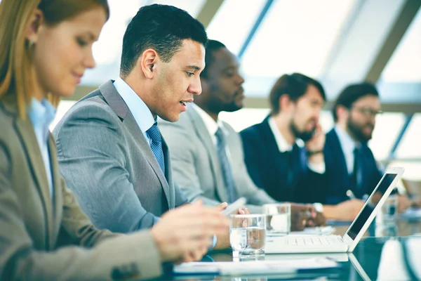 Business people listening to presentation