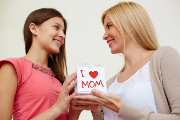 Teenage girl congratulating her mom