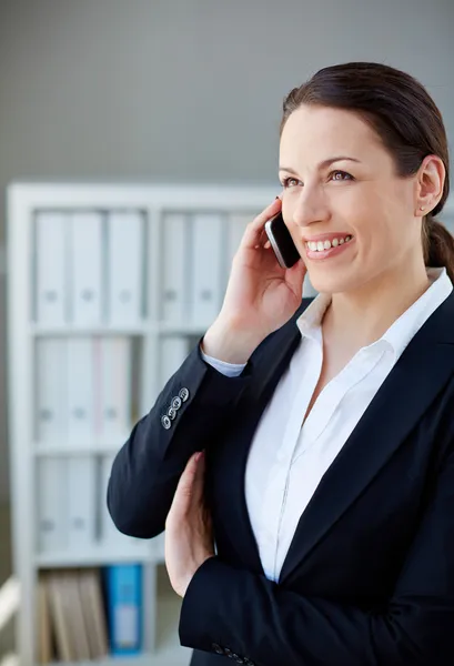 Pretty employee speaking on cellphone