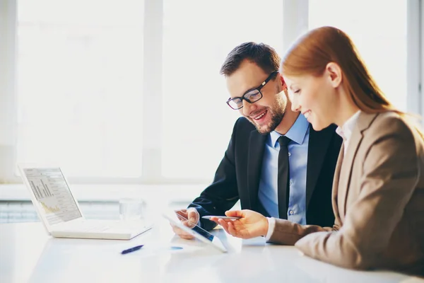 Business partners using touchpad