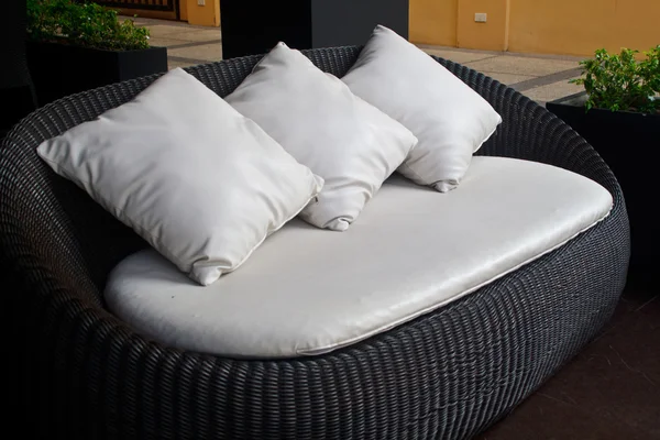 Black sofa white pillows.