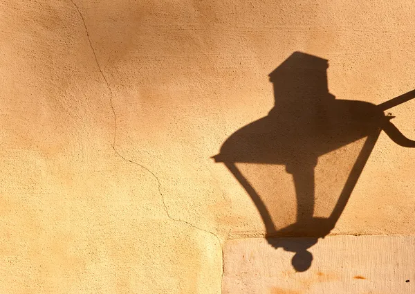 The shadow of street lamp on the wall