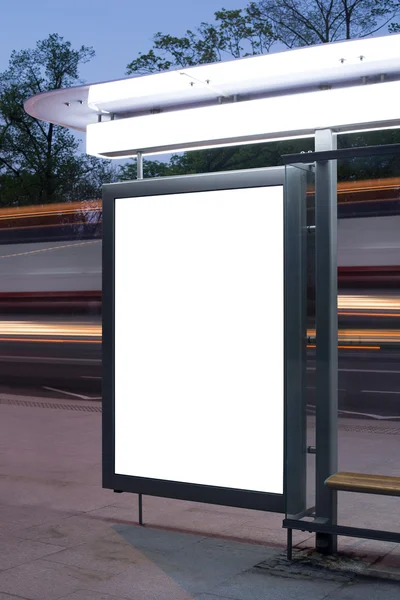 Blank billboard on bus stop at night