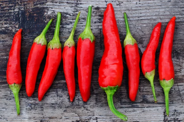 Red chili peppers on an old wooden background