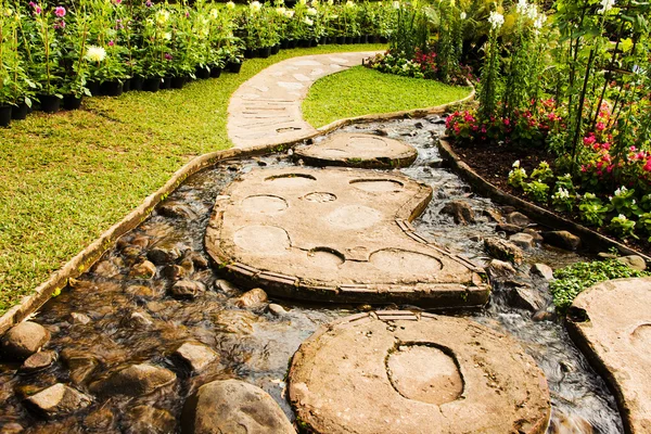 Landscape garden design. The path in the garden with pond in asi