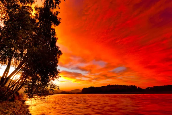 Red sunset sky over the river Katun. Altai. Russia