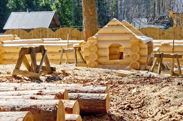 Construction plaschadka processing and assembly log cabins houses made of round timber with the bottom groove