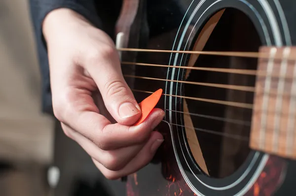 Female hand playing acoustic guitar.guitar play