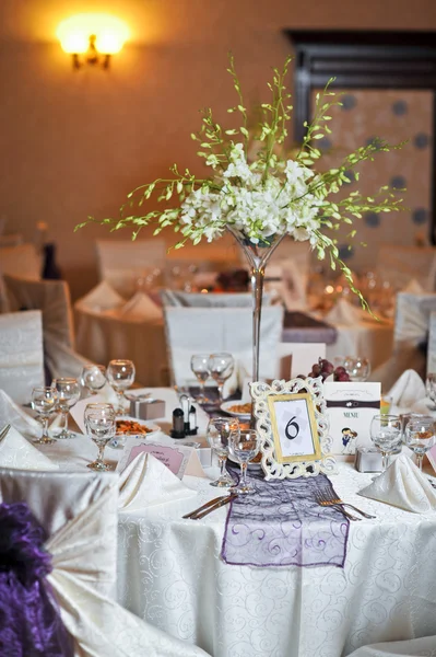 Wedding decorations with fruits, flowers and card. Elegant arrangements on wedding restaurant table. Floral arrangements and decorations