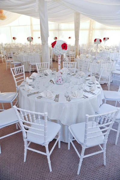 Wedding tables setting in white color. Tables set for an event party or wedding reception. Elegant table setting in restaurant. White arrangement for wedding.