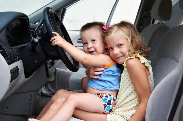 Young children are driving big cars