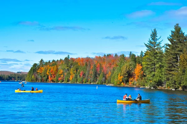 Autumn lake and people on boats