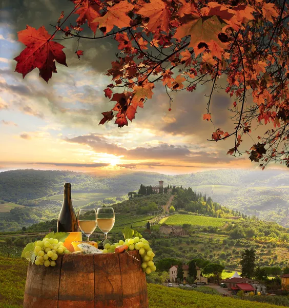 White wine with barrel on vineyard in Chianti, Tuscany, Italy