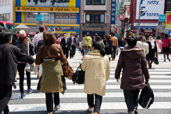 Tourists and business people crossing the street