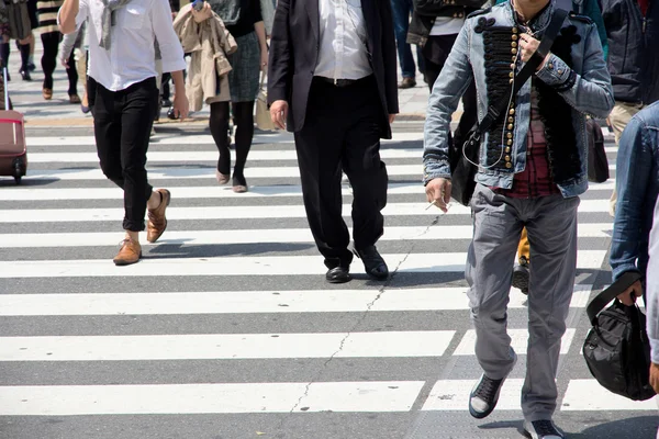 Tourists and business people crossing the street