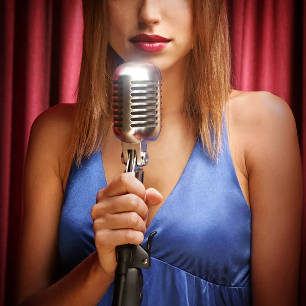 Beautiful singer singing with a retro microphone
