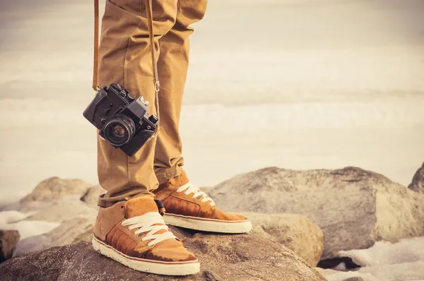 Feet man and vintage retro photo camera outdoor Travel Lifestyle vacations concept
