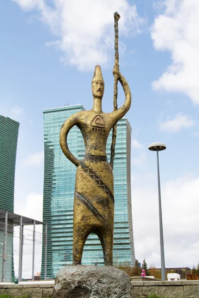 Bronze sculpture on glass background of the business center in Astana