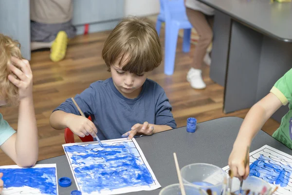 Kid Painting at Kindergarten