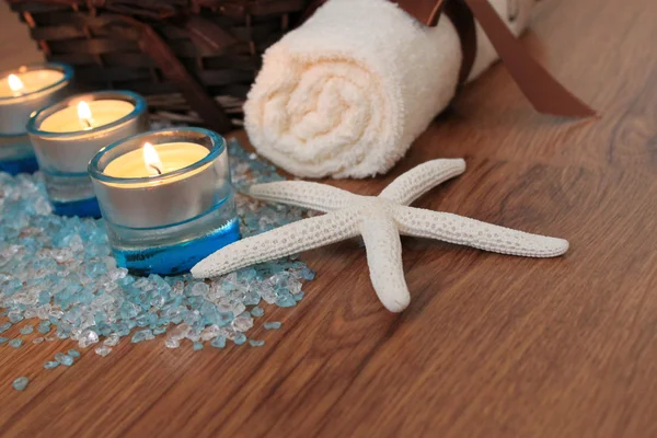 Spa concept with blue candles, bath salt and starfish