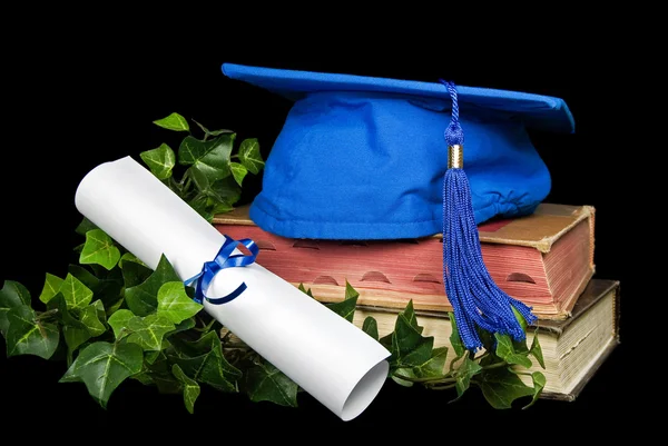 Blue graduation cap on books