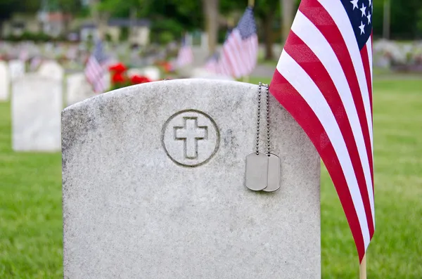 Dog tags on veteran's tombstone