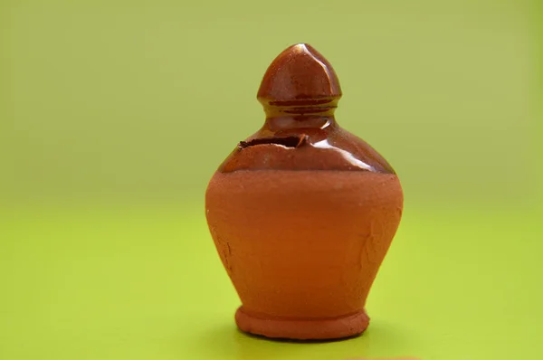 Clay Pottery bank on green background
