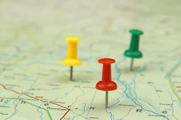 Colorful push pins on a road map