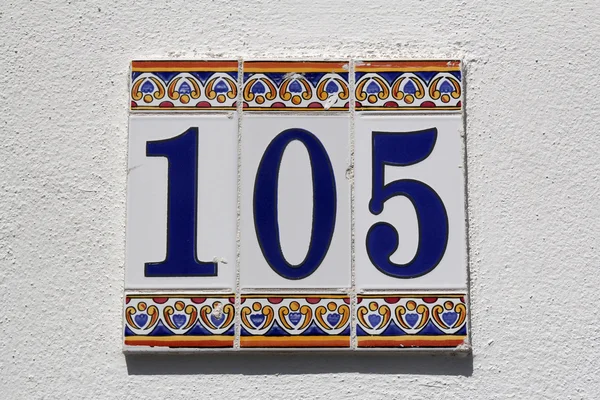 Number one hundred and five, house address plate number