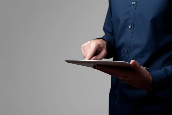 Man holding and touching digital tablet