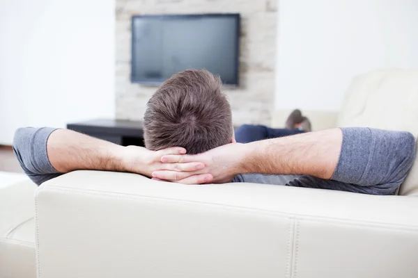Relaxed man watching tv