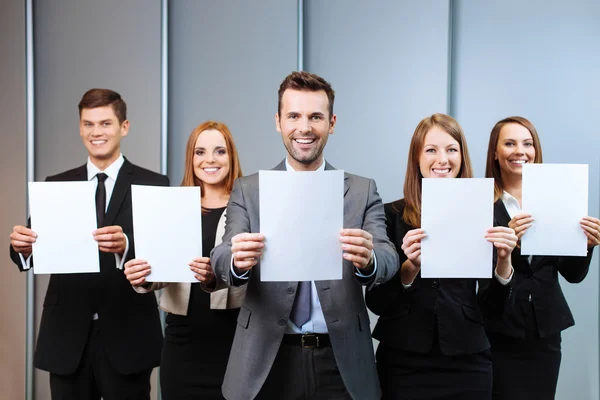 Business people holding blank cards